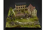 A detailed 1/72 scale diorama of the Battle of Austerlitz featuring miniature soldiers, cavalry, and buildings on a grassy base.
