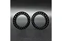 Two black aluminium beadlock rings for 1.9 inch RC wheels, shown side by side against a dark grey background.