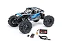 Axial UTB18 Capra 4WS RC rock crawler in blue and grey, shown with included Spektrum battery, USB charger, and cable on a white background.