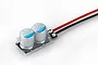 A Hobbywing ESC capacitor pack featuring two silver electrolytic capacitors mounted on a small black circuit board with red and black wires.