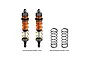 Two GPM Racing orange aluminium adjustable front RC shocks with gold springs, alongside two additional black replacement springs on a white background.