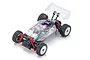 Kyosho Mini-Z MB-010VE 2.0 SP RC buggy chassis with a clear, unpainted body shell, red shock absorbers, and off-road tires on a white background.