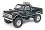A black 1/24 scale Axial SCX24 1967 Chevrolet C10 RC rock crawler truck viewed from a front three-quarter angle on a white background.