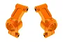 A pair of bright orange anodized aluminium rear hub carriers for an RC car, shown against a plain white background.