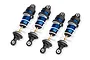 Four Traxxas blue anodized aluminium Mini GTR long shock absorbers with white springs arranged on a white background.