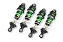 Four Traxxas green anodized aluminium Mini GTR long shock absorbers with white springs arranged on a white background.