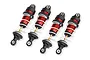 Four Traxxas Mini GTR long shock absorbers with red anodized aluminum bodies, white springs, and black plastic components.