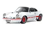 A studio shot of a white Tamiya Porsche 911 Carrera RSR 2.8 RC car model with red wheels and red Carrera side decals against a plain white background.