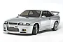 A silver Tamiya Nissan Skyline GT-R R33 RC drift car model on a white background.