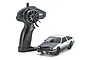 Kyosho First Mini-Z Initial D Toyota Sprinter Trueno AE86 RC car in white and black with its black pistol-grip transmitter on a white background.