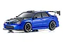 A studio shot of a metallic blue Kyosho Mini-Z Subaru Impreza WRX RC drift car with a carbon fiber look hood and large rear spoiler.