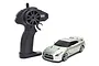A silver Kyosho First Mini-Z Nissan GT-R R35 RC car next to its black pistol-grip radio transmitter on a white background.