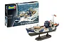 A Revell 1/144 scale Kriegsfischkutter model kit box next to a fully assembled and painted model of the warboat on a display stand.