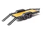 Axial 1/24 scale flat bed vehicle trailer with black diamond plate fenders, yellow deck, and dual axles, shown from a rear three-quarter angle.