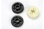 Two black plastic gears and one off-white plastic gear component for a Traxxas RC gearbox.