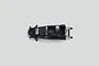 A top-down view of a black Tamiya RC main chassis component on a plain light grey background.