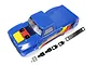 A blue Kyosho Outlaw Rampage T2 RC truck body shell with yellow, red, and black decals, along with a black grille and mounting hardware on a white background.
