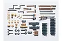 A collection of painted 1/35 scale plastic model tank equipment parts, including tools, track links, and accessories on a white background.