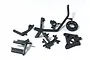 A set of black plastic RC car chassis support parts on a white background, including various brackets and a circular mount.