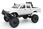 A white WPL C64-1 Hilux RC rock crawler truck with large off-road tires, a bull bar, and roof-mounted spotlights against a white background.