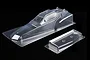 A clear, unpainted polycarbonate RC buggy body shell and rear wing for the Tamiya Hornet Evo on a black background.