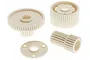 A set of four off-white plastic RC car gears and a spacer plate on a white background.