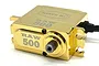 Reefs RC RAW500 brushless metal gear servo in a polished gold brass finish, viewed from a high angle against a white background.