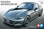 Box art for Tamiya 1/24 scale Mazda Roadster RF plastic model kit featuring a grey sports car on a dark road background.