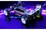 XRAY XB2'26 1/10 scale 2WD electric RC buggy kit in a studio setting with neon purple lighting effects.