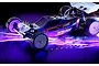 A studio shot of the XRAY XB2'26 1/10 scale 2WD electric RC buggy on a dark background with vibrant purple and blue neon lighting effects.