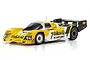 Kyosho Mini-Z 1987 Porsche 962 C LM RC car in yellow, white, and black Taka-Q livery, shown from a front-quarter angle on a white background.