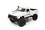 A white WPL C24-1 1/16 scale RC rock crawler pickup truck viewed from a high angle against a white background.