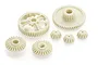 A set of various off-white plastic RC car gears for the Tamiya Novafox, arranged on a white background.