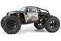 Side profile of a grey HPI Venture 18 RC rock crawler with black wheels and orange shock absorbers on a white background.