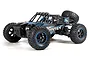 BlackZon Smyter DB 1/12 scale RC desert buggy in blue and black, featuring a roll cage, spare tire, and off-road tires.