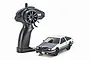 Kyosho First Mini-Z Toyota Sprinter Trueno AE86 RC car in white and black with its matching black pistol-grip remote controller on a white background.