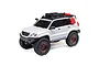 Axial SCX24 Lexus GX 470 RC rock crawler in white with off-road accessories, roof rack, and bronze wheels on a white background.
