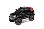 A black Axial SCX24 Lexus GX 470 RC rock crawler with off-road accessories on the roof rack, shown against a white background.