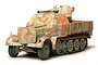 A Tamiya 1/35 scale plastic model kit of a German Sd.kfz. 7/2 armoured vehicle with camouflage paint, shown from a front three-quarter angle.