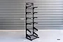 A black Koswork metal floor display stand with multiple hooks and two wire baskets, featuring dimension labels indicating a height of 1340mm.
