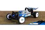 Maverick MiCROBE 1/24 scale RC buggy in blue and silver, featuring white wheels and a rear wing, positioned on a textured outdoor surface.