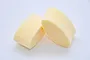 Two pale yellow cylindrical foam air filter elements for an RC engine.