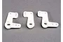 Three white plastic bell crank steering components for a Traxxas RC vehicle arranged on a grey surface.