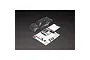 An unpainted clear polycarbonate RC truck body shell for the Arrma Vorteks, shown with a decal sheet and window masks on a black background.