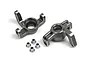 A pair of silver aluminium steering hubs for an RC car, accompanied by four small metal bushings on a white background.