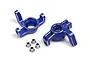 Two blue anodized aluminium steering hubs and four small metal bushings on a white background.