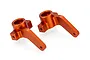 Two orange anodized aluminium steering hubs for an RC car, shown from an elevated angle against a white background.