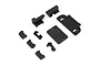 A collection of black plastic RC chassis parts including brackets, a cover plate, and a honeycomb-patterned mount.
