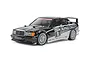 A studio shot of a Tamiya 1/10 scale RC Mercedes-Benz 190 E 2.5-16 EVO II touring car model with black and white racing livery on a white background.
