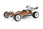 A studio shot of a Team Associated RC10 B84 1/10 scale 4WD electric RC buggy, featuring an orange and blue painted body shell, white wheels, and a rear wing.